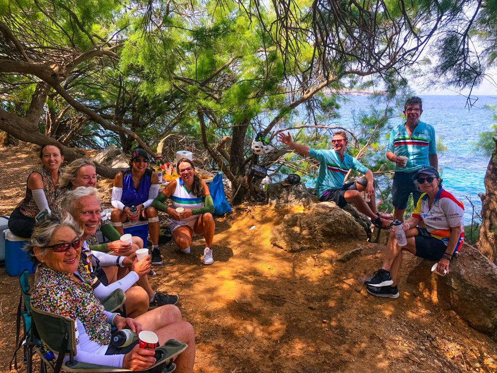 group bike tour mallorca resting by the sea